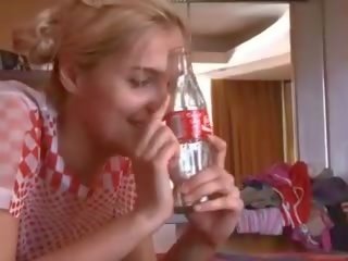 Young blond student uses bottle