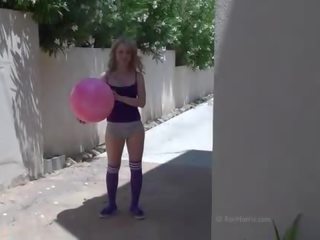 Playful blonde teen in shorts stripps and teases outdoor